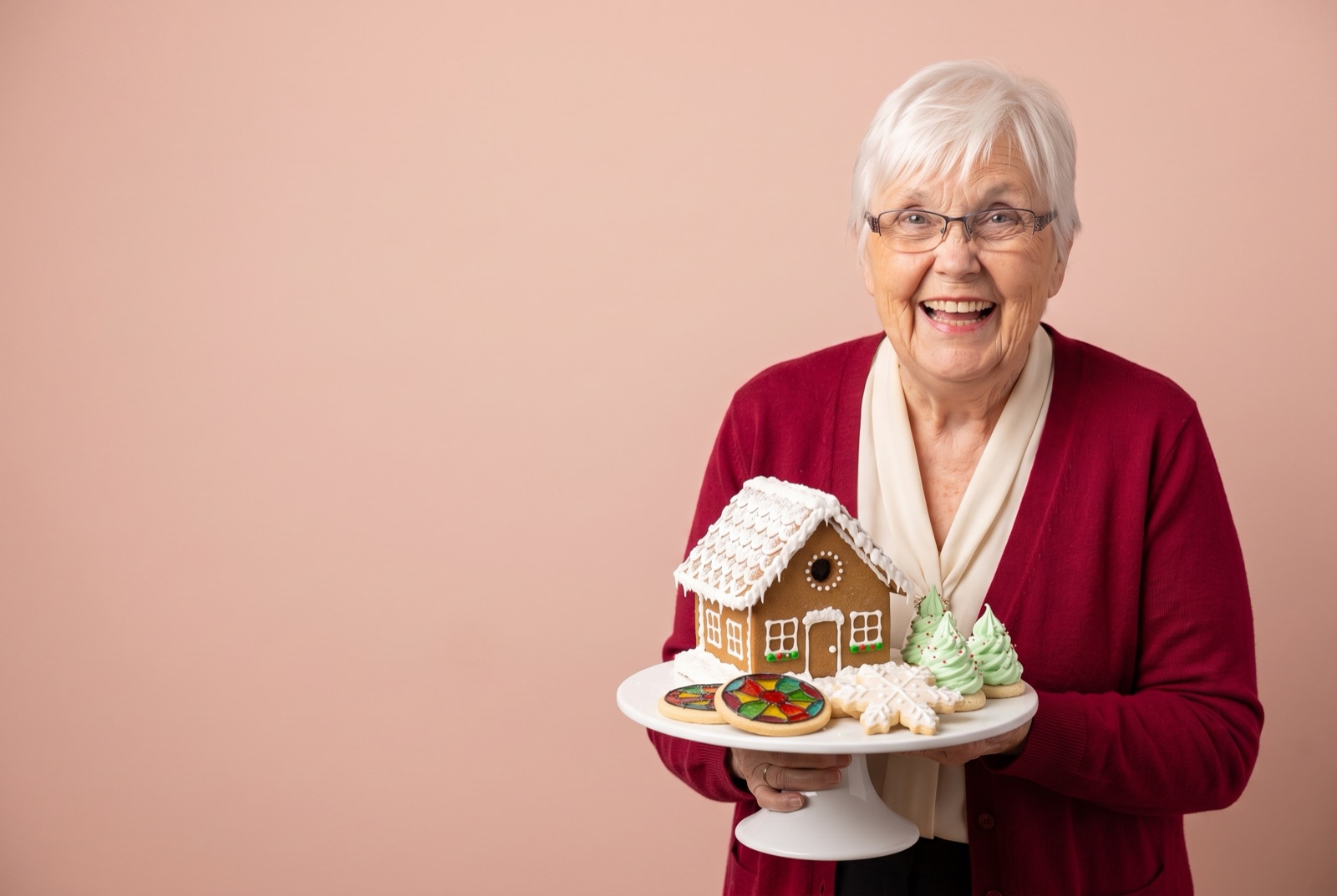 Grandma Carol holding a gingerbread house